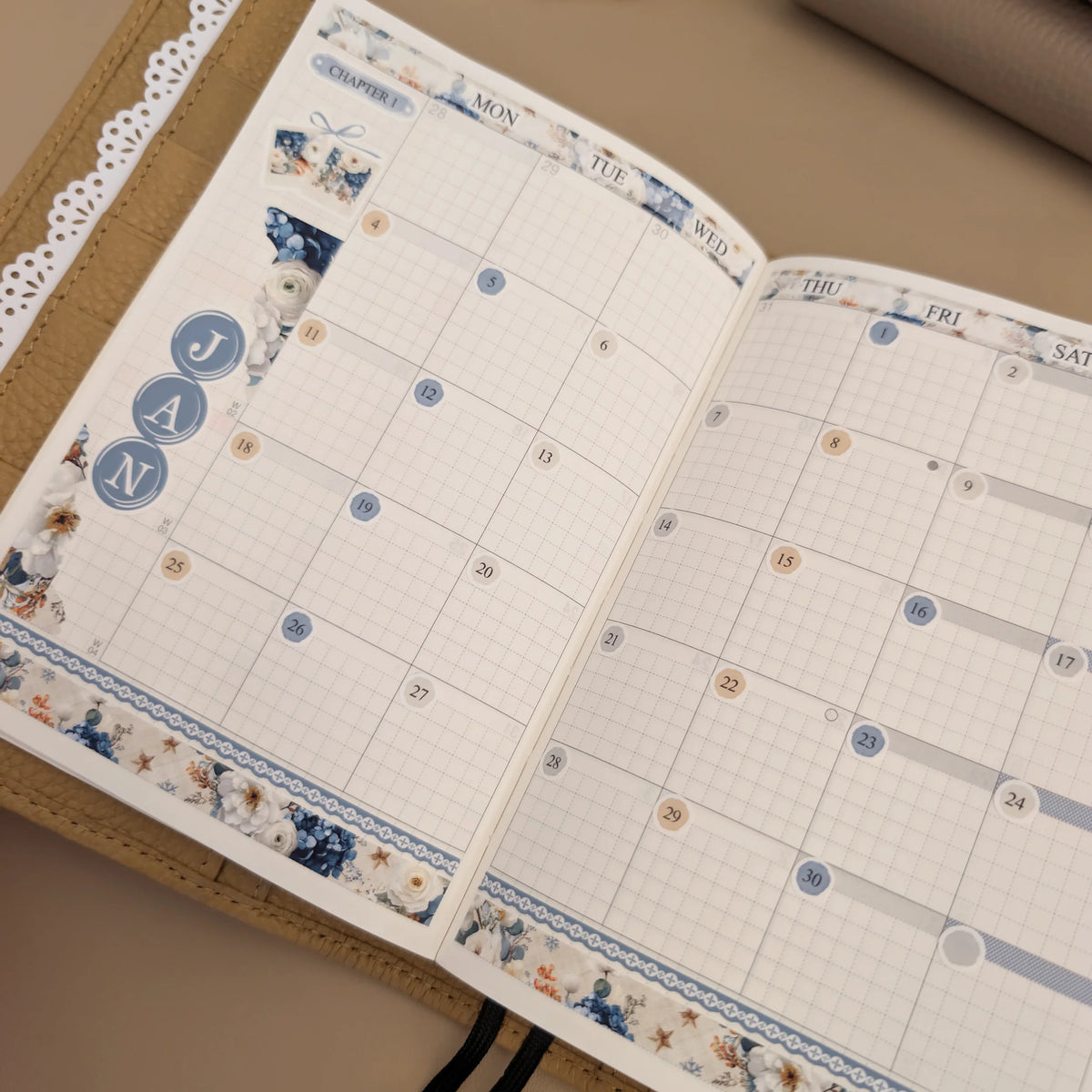 January floral monthly sticker kit installed in the calendar pages of a Hobonichi Techo A6